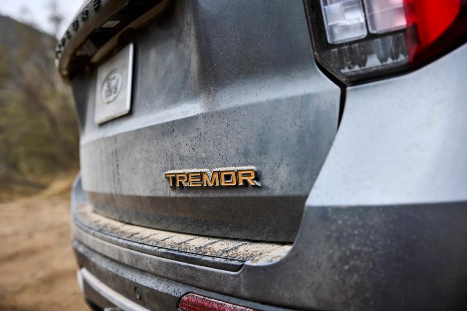 The orange "Tremor" badge on the tailgate of a Ford Explorer SUV, the desert visible in the background.