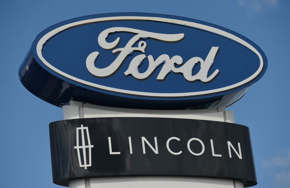 The Ford and Lincoln logos above a dealership doing SUV recall work