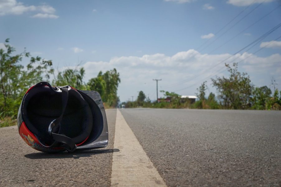A helmet sits next to the road shoulder after a bad motorcycle crash.
