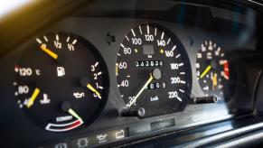 An older Mercedes-Benz shows off its odometer as a high-mileage car.