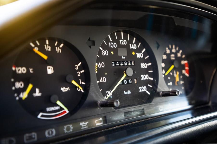 An older Mercedes-Benz shows off its odometer as a high-mileage car.