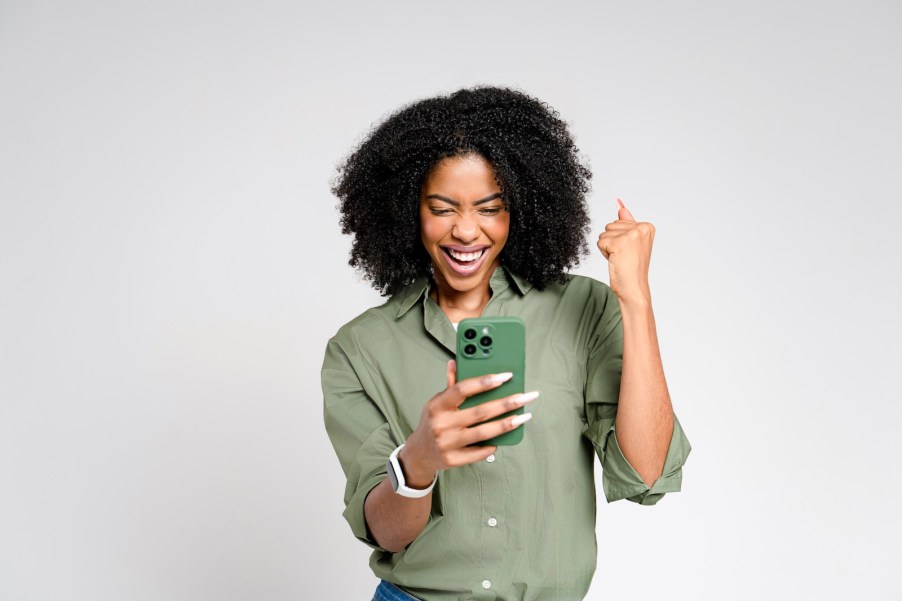 Charli XCX laughs at photo on her phone of Ford logo looking like "Brat"