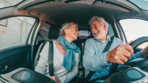 Couple smiles at each other while stealing Jaguar E-Pace back