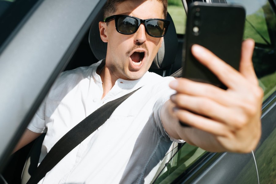 Man takes a selfie while sitting in a stolen Hellcat Trackhawk Jeep