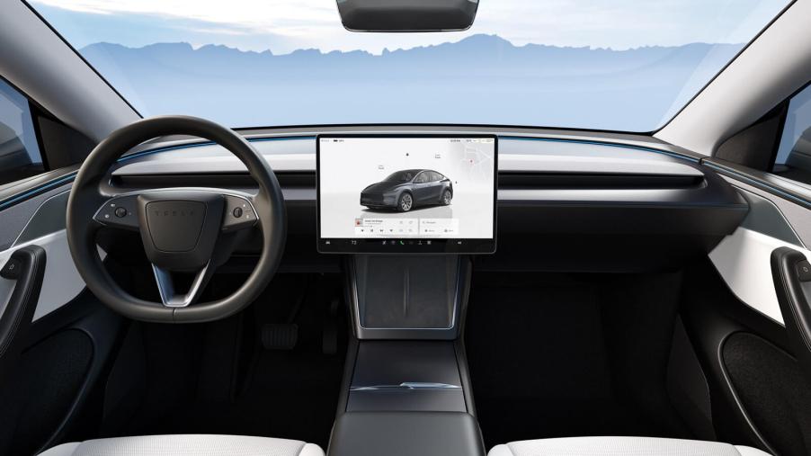 The interior of a new 2026 Tesla Model Y, which has an open recall for a windshield visibility issue.