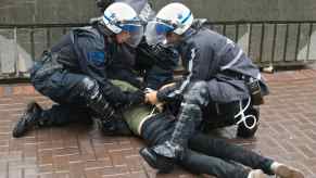 Police officers sit on top of driver who had a Turo rental car reported stolen.
