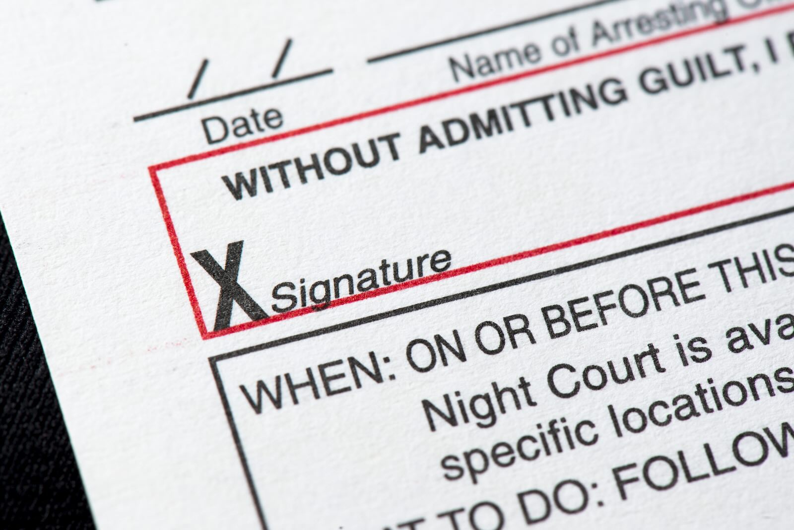 Closeup of the signature line on a speeding ticket.