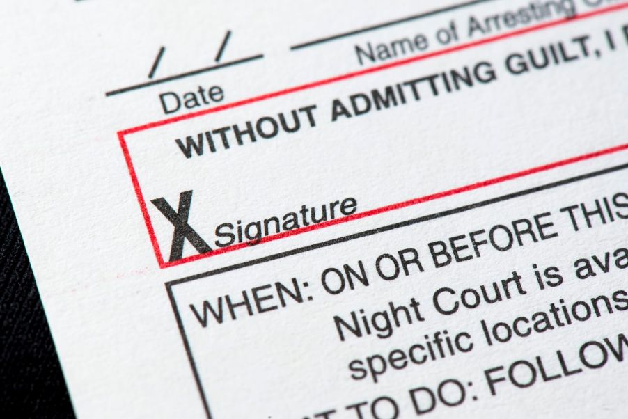 Closeup of the signature line on a speeding ticket.