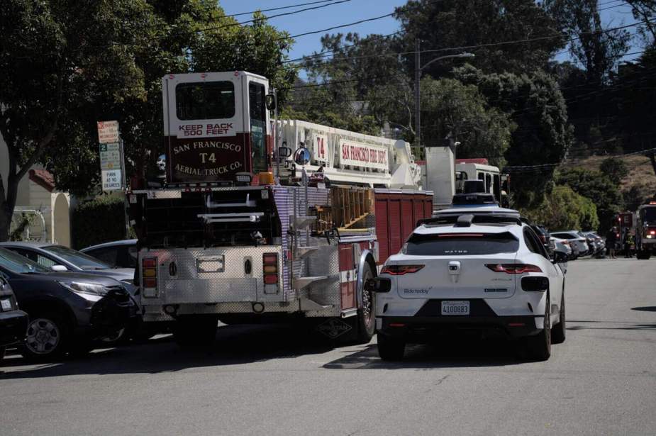 A Waymo EV with a fire truck in San Francisco