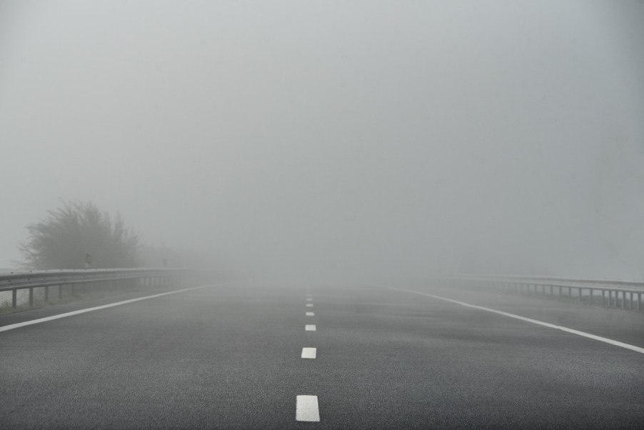 This road disappearing into the fog may cause white line fever.