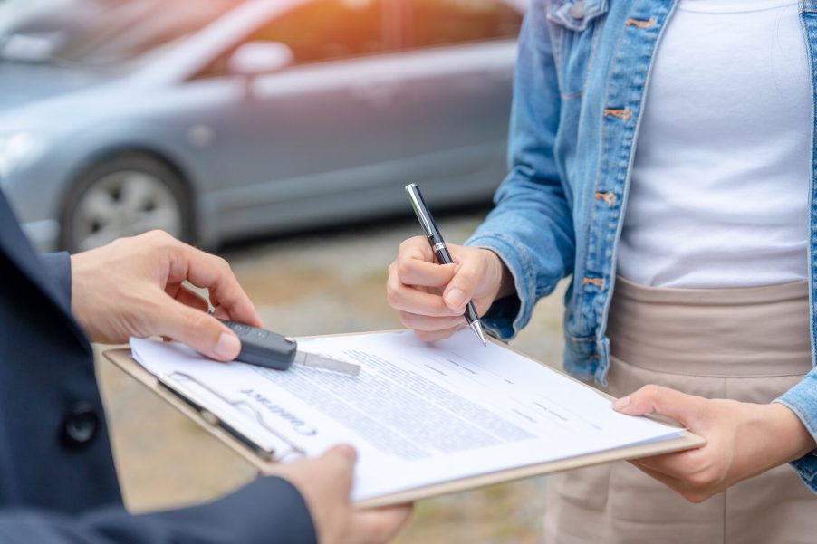 Buying a car contract on clipboard