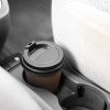 Coffee in a car's built-in center console cupholder.