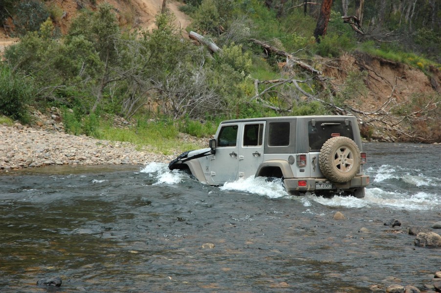 A Jeep Wrangler crossing a river
