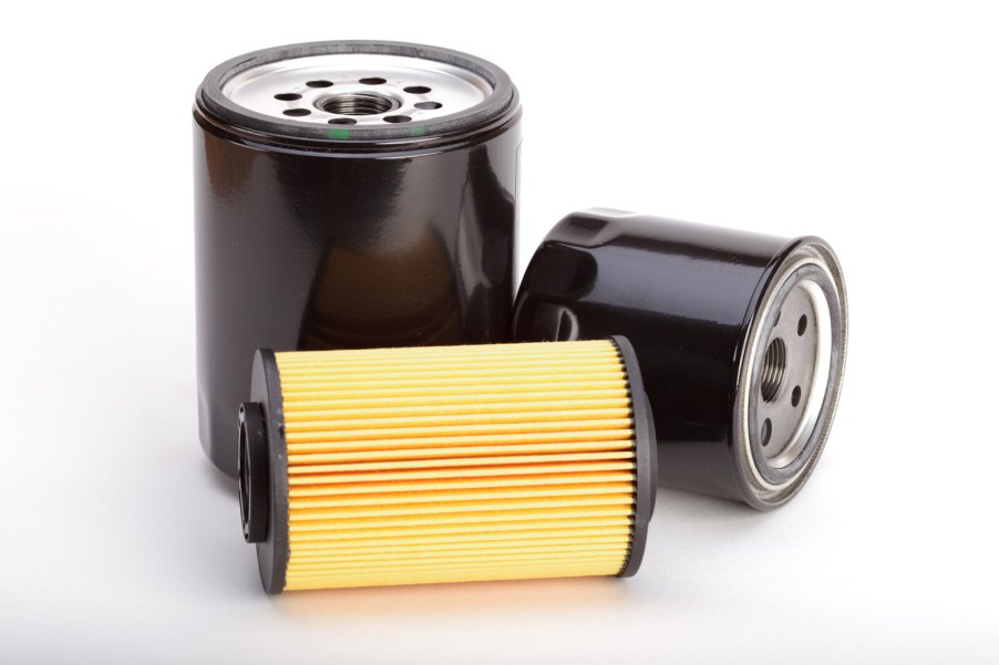 Three different car engine oil filters on a white background