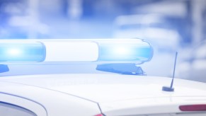 A police car with roof lights going in very close view