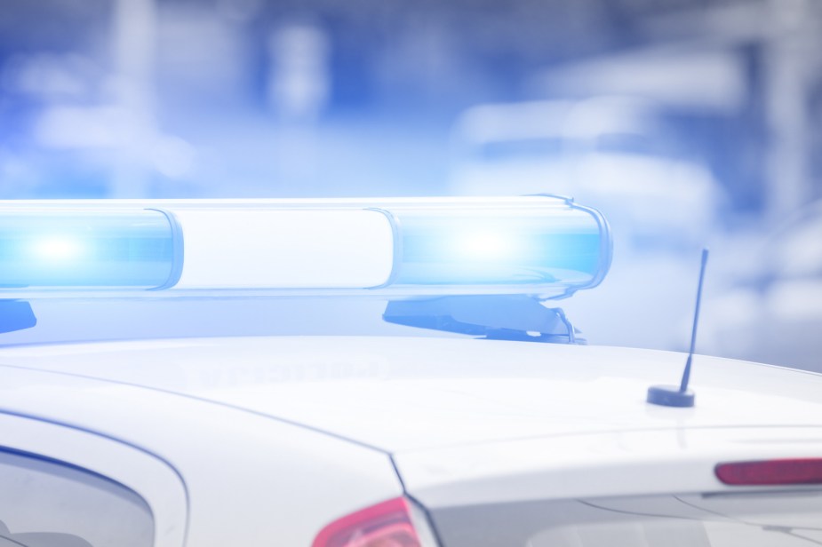 A police car with roof lights going in very close view