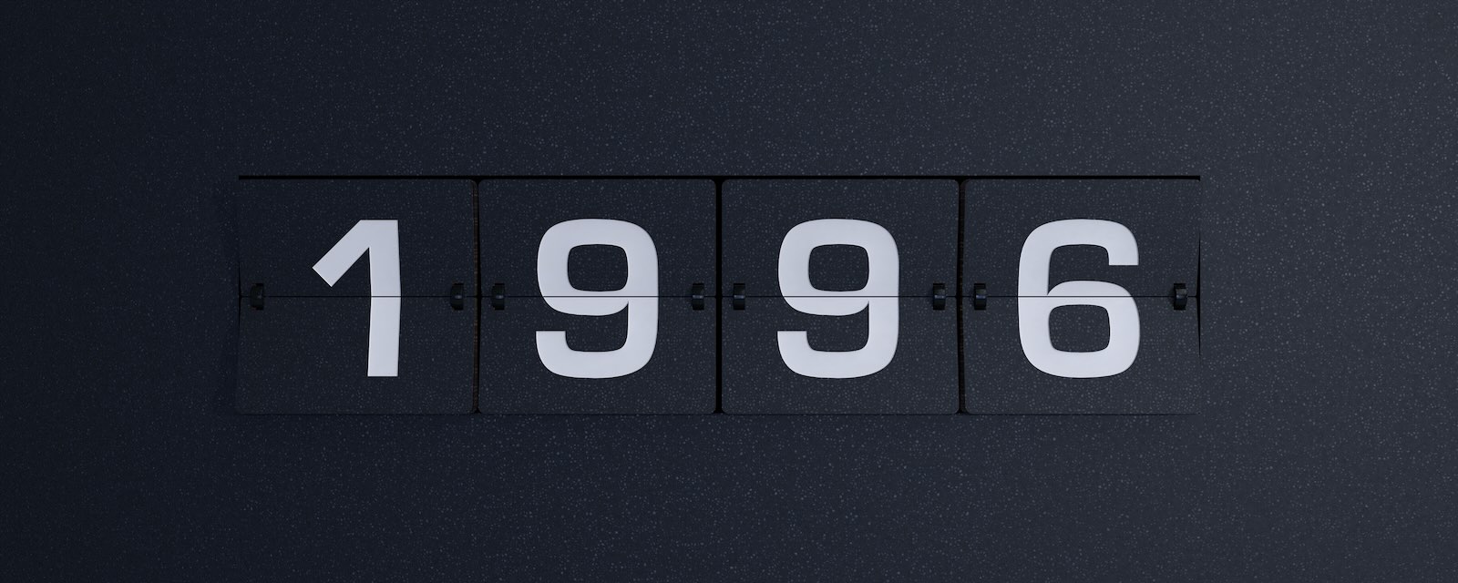 Alarm clock flipboard that reads "1996" over a black background.