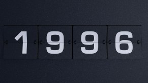 Alarm clock flipboard that reads "1996" over a black background.