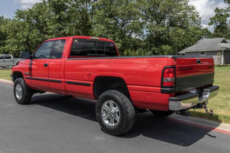 A red 1999 Dodge Ram 2500 truck parked in left rear angle view