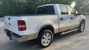 A white 2008 Ford F-150 parked in right rear angle view