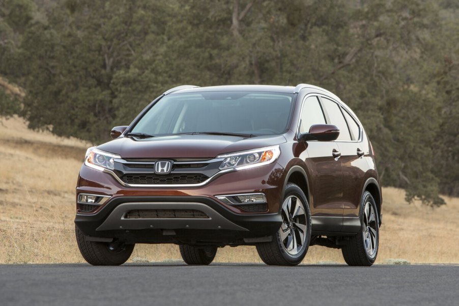 A 2015 Honda CR-V parked on a paved road in left front angle view