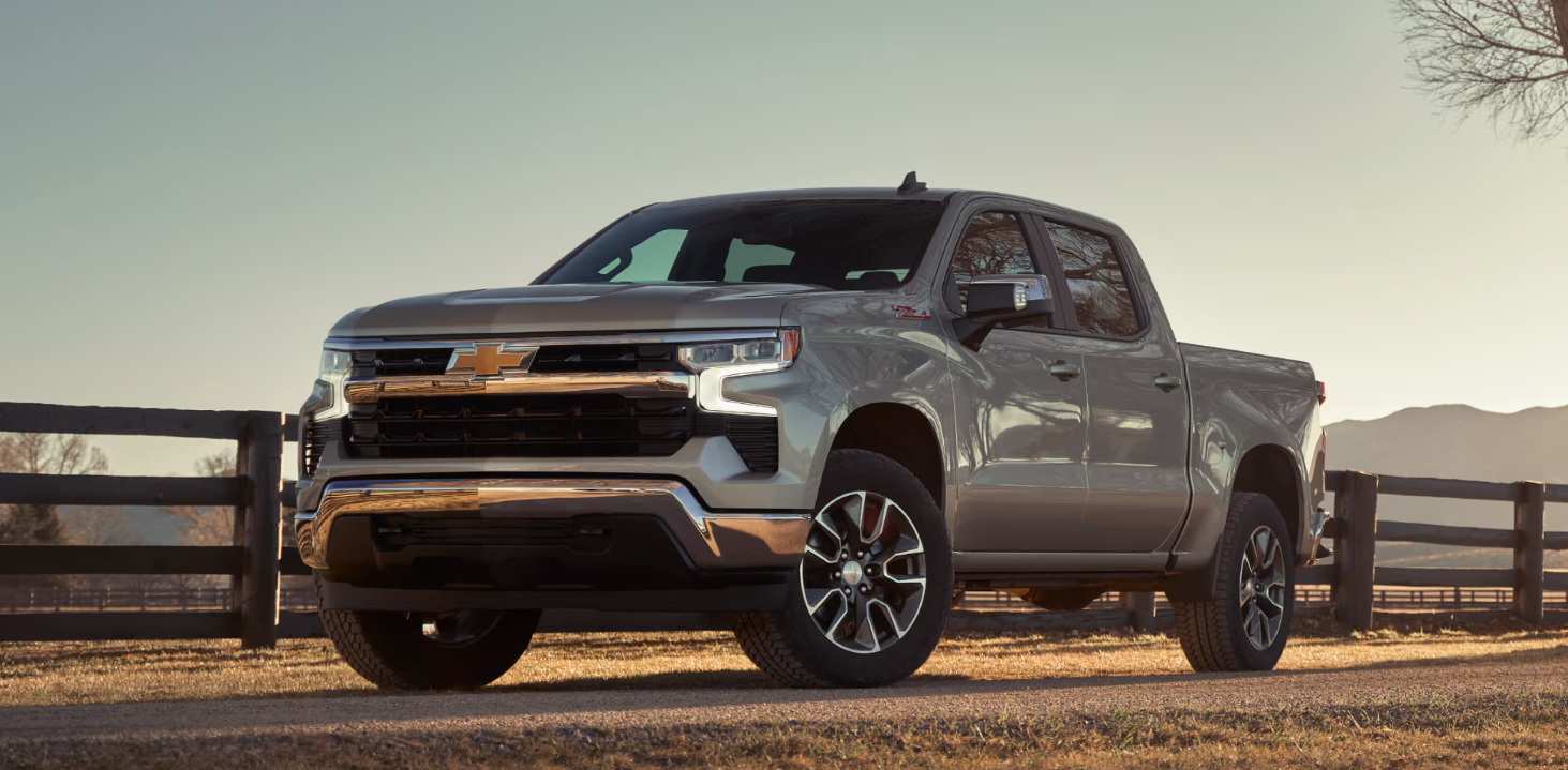 The 2025 Chevy Silverado 1500 near a fence