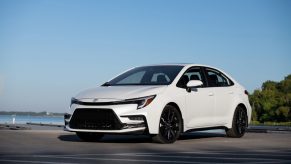 A white 2025 Toyota Corolla parked outside in left front angle view