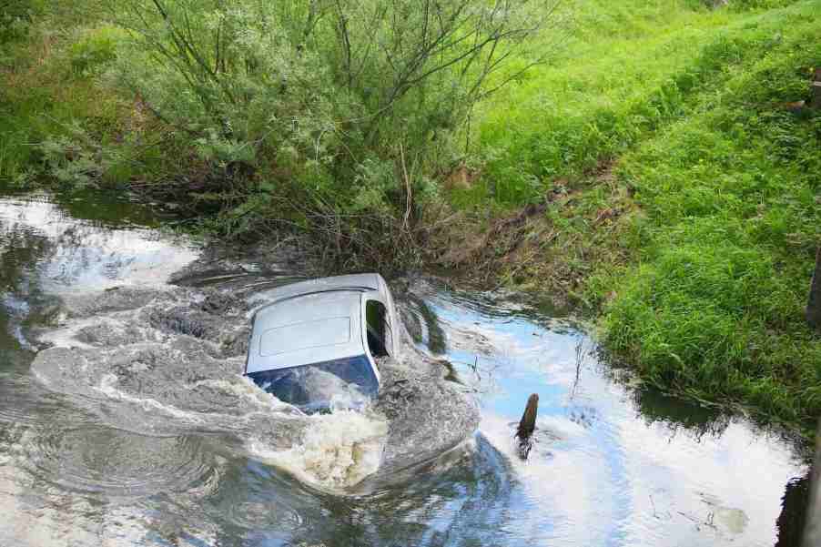 Silver Ford Mustang forced into Texas river by Silverado pickup truck