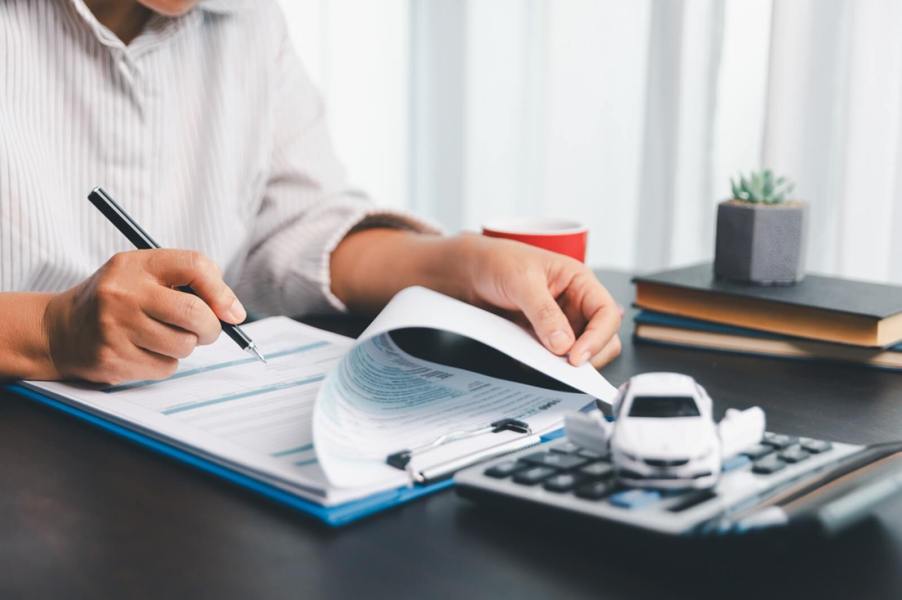 A person works on a car insurance policy.