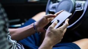 A person pours over content on their smartphone, like a case of a woman who live-streamed her DUI in South Korea.