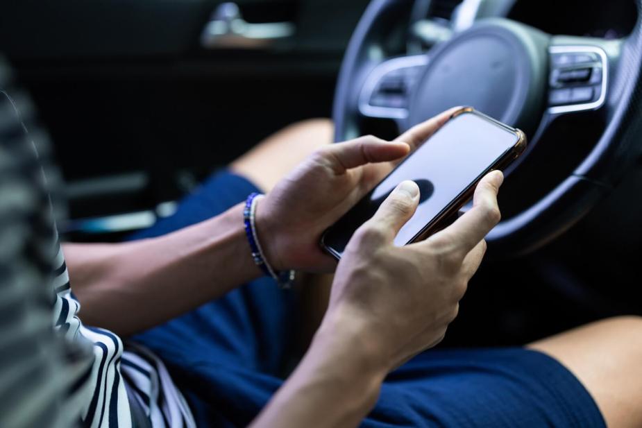 A person pours over content on their smartphone, like a case of a woman who live-streamed her DUI in South Korea.