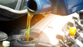 Pouring oil into an engine during a change.