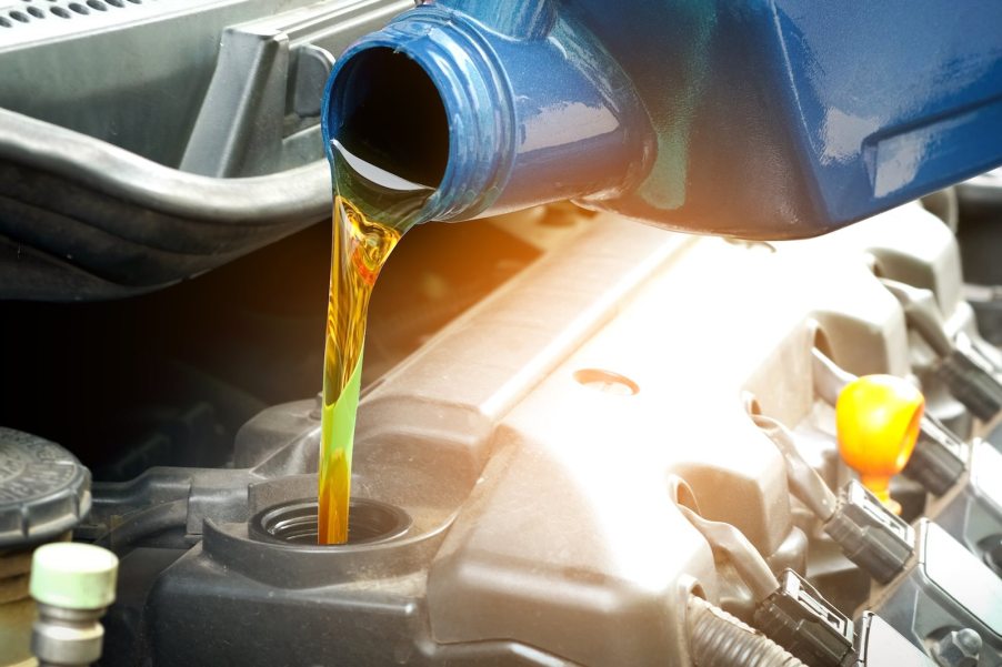 Pouring oil into an engine during a change.