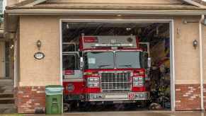 Bright red fire truck parked in a home garage