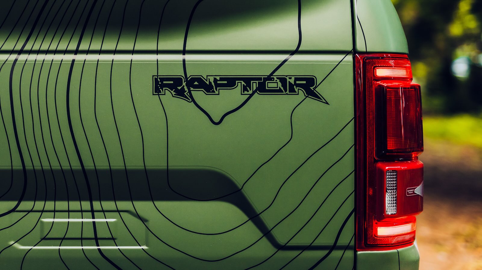 Green Ford Raptor tailgate badge.