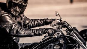 A Harley-Davidson rider takes a ride on their Dyna in a black-and-white image.
