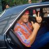 Hulk Hogan, legendary wrestler and car collector smiles in the back seat of a car.