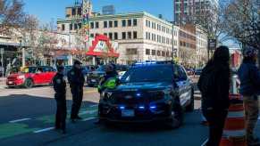 Police in Massachusetts respond to an emergency on a busy street.