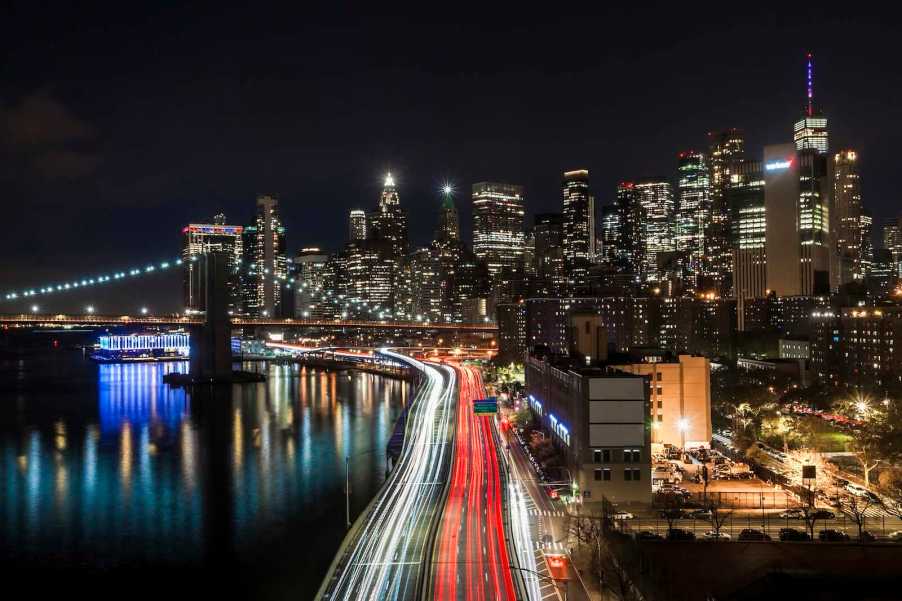 Night time traffic flows over the Brooklyn Bridge and through Manhattan.