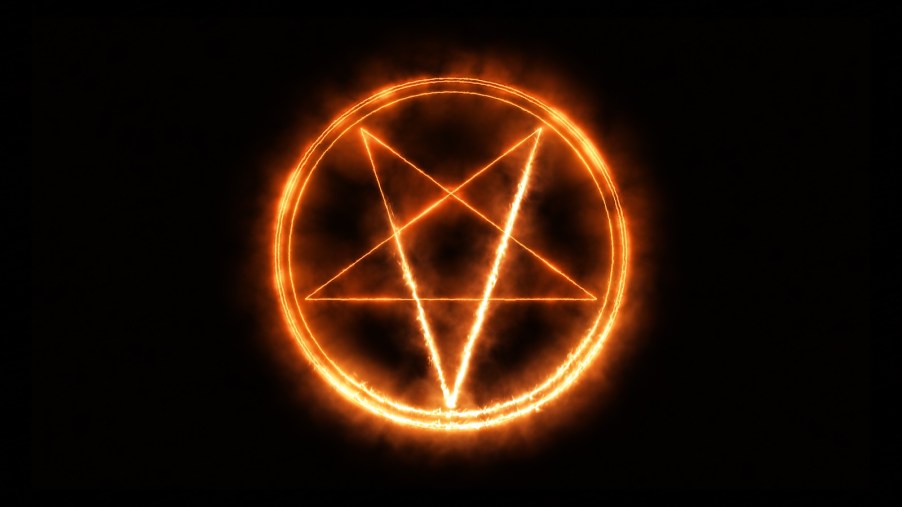 Burning Pentacle symbol from Taro on a black background.