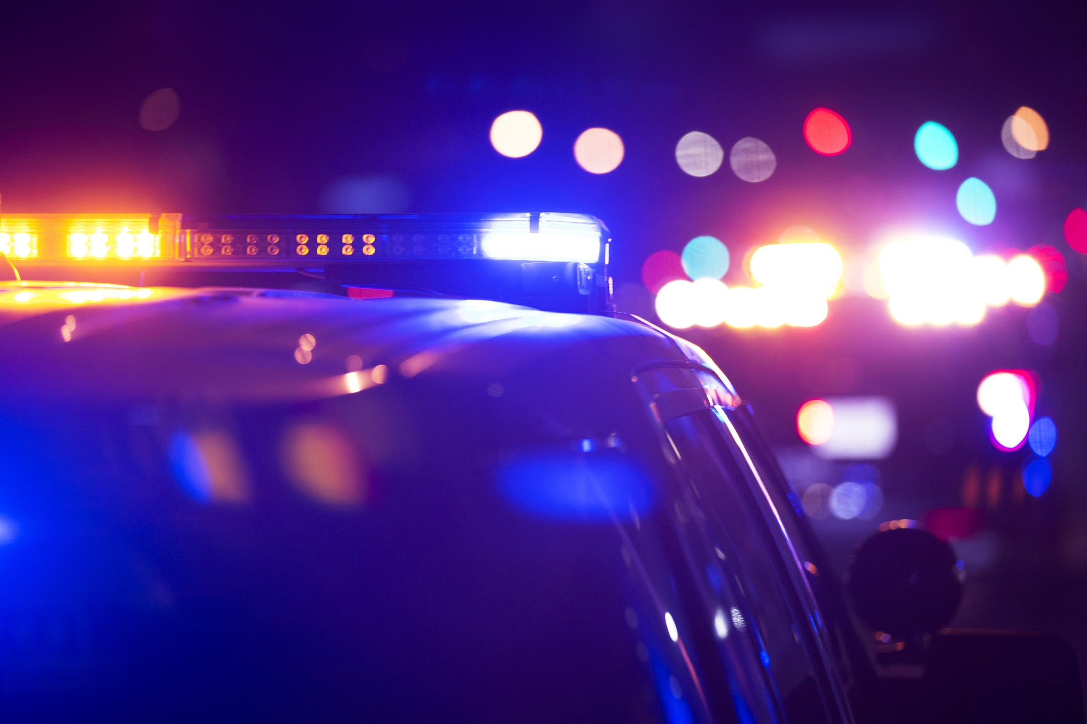 Police cars with their lights on at night