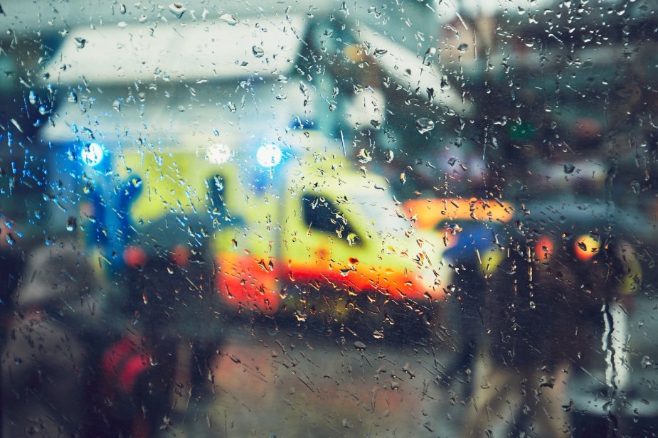 An ambulance at an accident on a rainy day