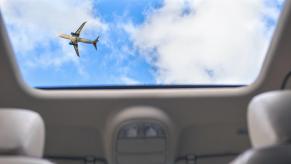 A sunroof shows the sky through a roofline.