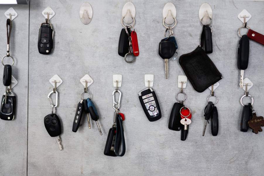 A wall displays many sets of car keys, some of which could go missing and require replacement.