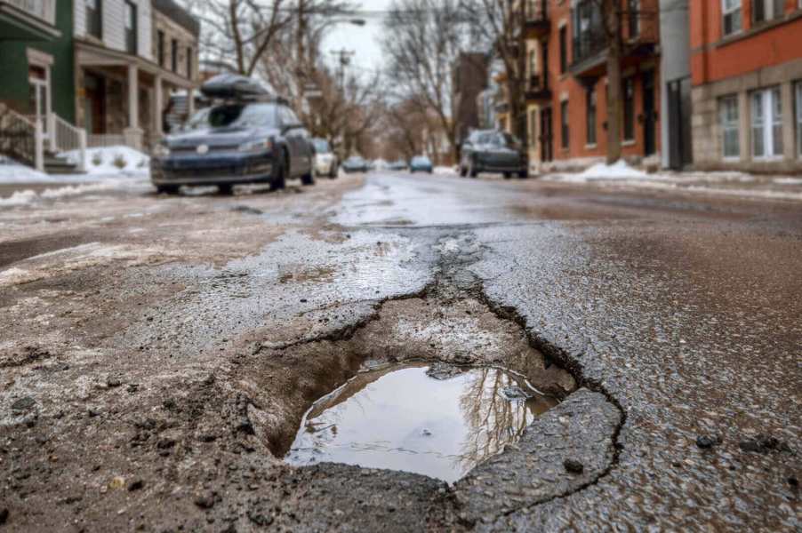 A pothole in a city street illustrates how damaging these menaces can be for your car's suspension, tires, and wheels.