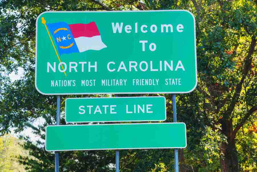 A highway sign reading "Welcome to North Carolina" and highlighting a state line