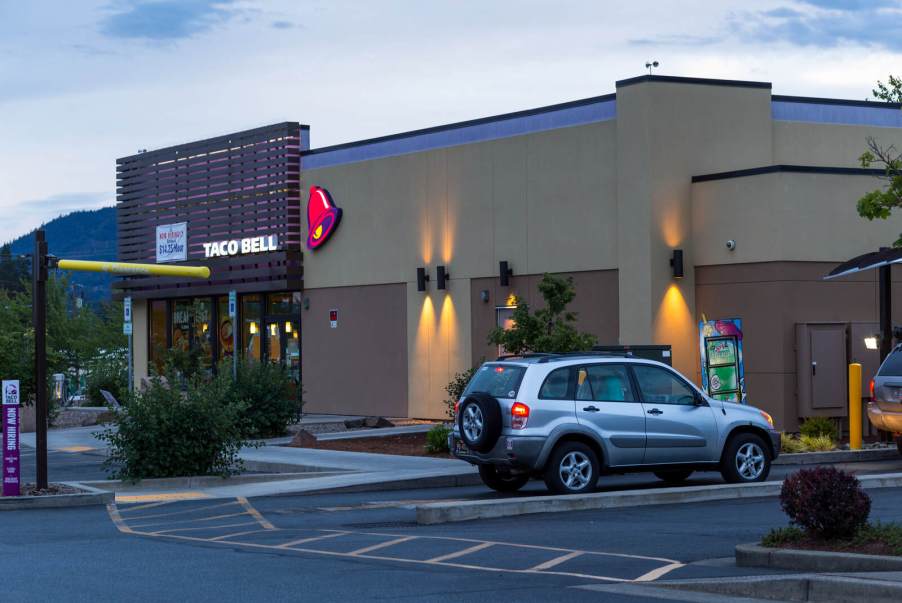 A Taco Bell restaurant drive-thru at dusk