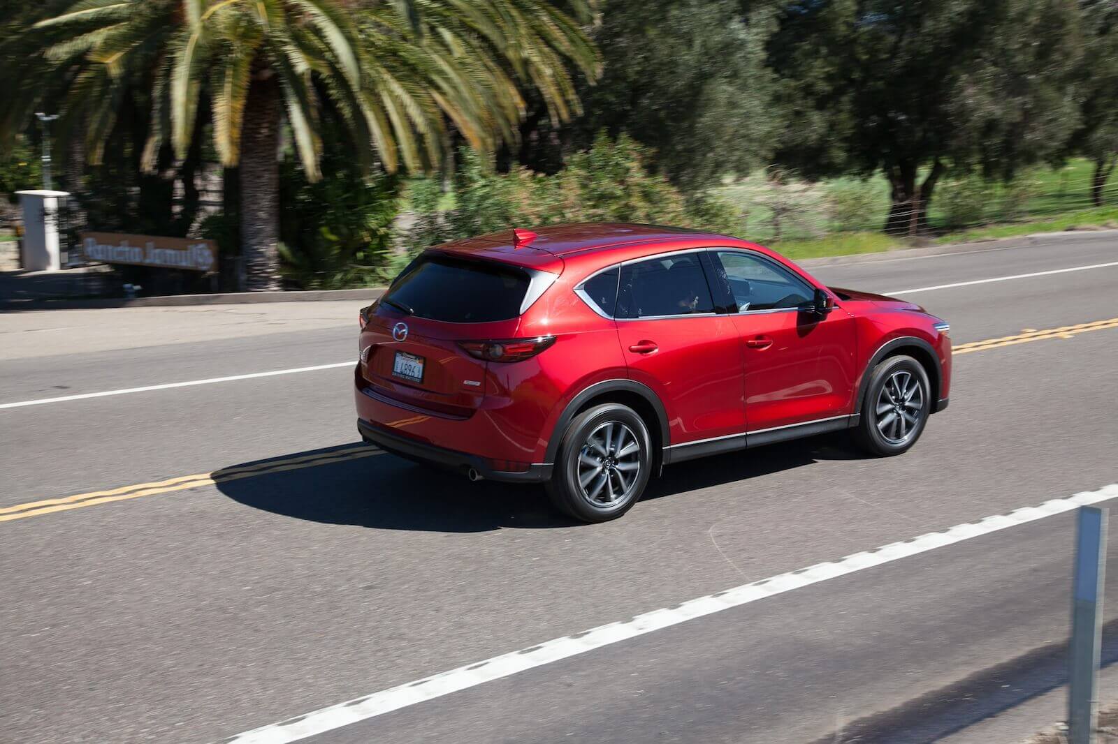 A 2017 Mazda CX-5 driving on a coastal road.