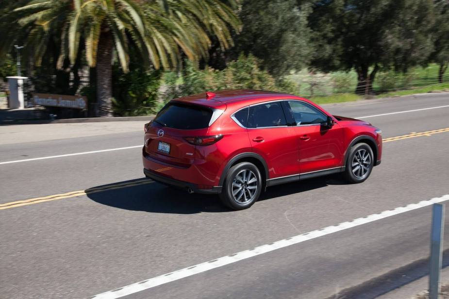 A 2017 Mazda CX-5 driving on a coastal road.