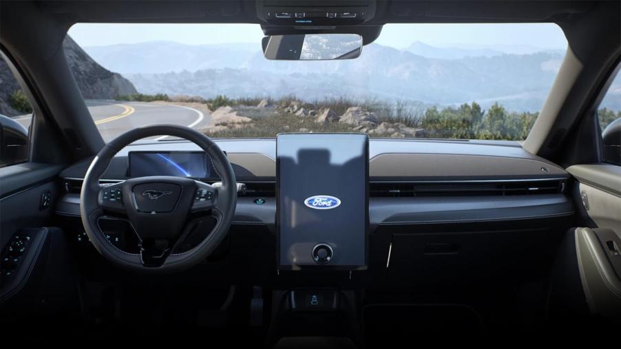 A Ford Mustang Mach-E shows off its interior and Blue Oval emblem on the center screen.